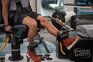 athlete performing isokinetic exercise on machine