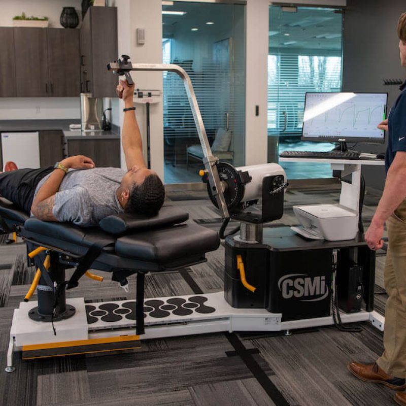 patient using arm attachment on humac norm isokinetic extremity system